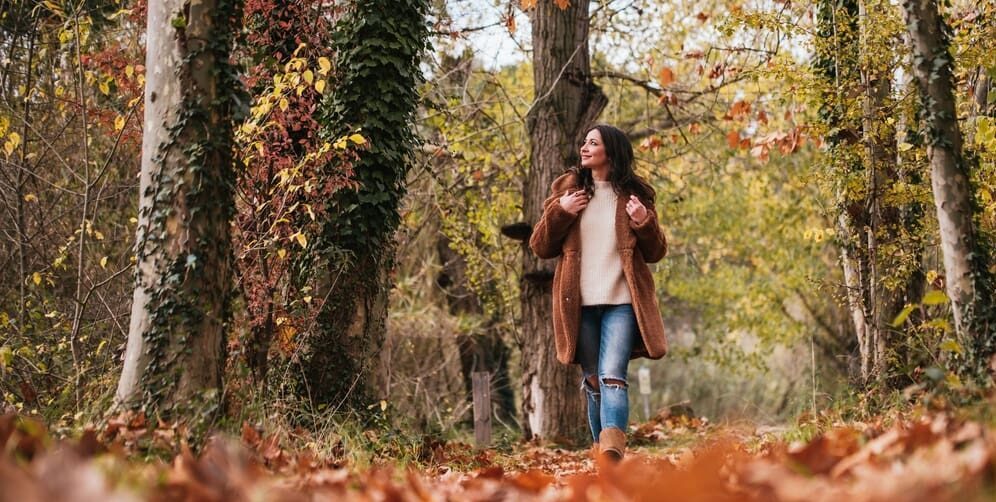 Low,View,Of,Woman,Walking,On,A,Path,Full,Of